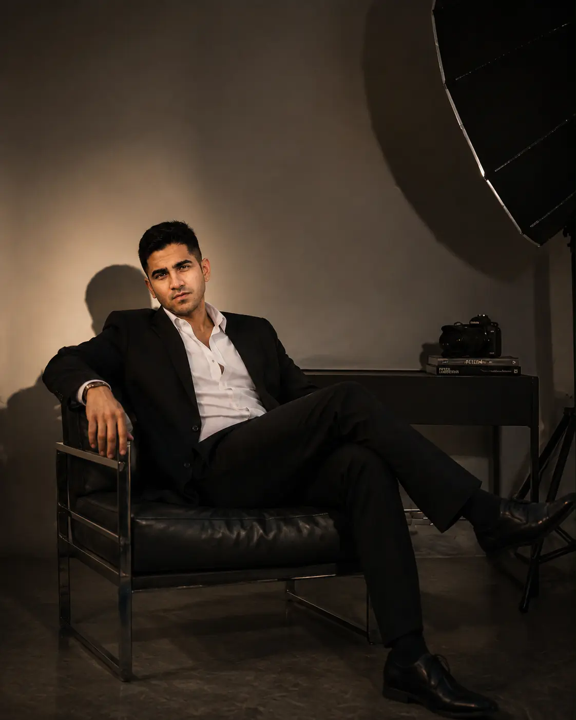 Arshaan Gandhi, wedding and celebrity photographer, seated in his studio