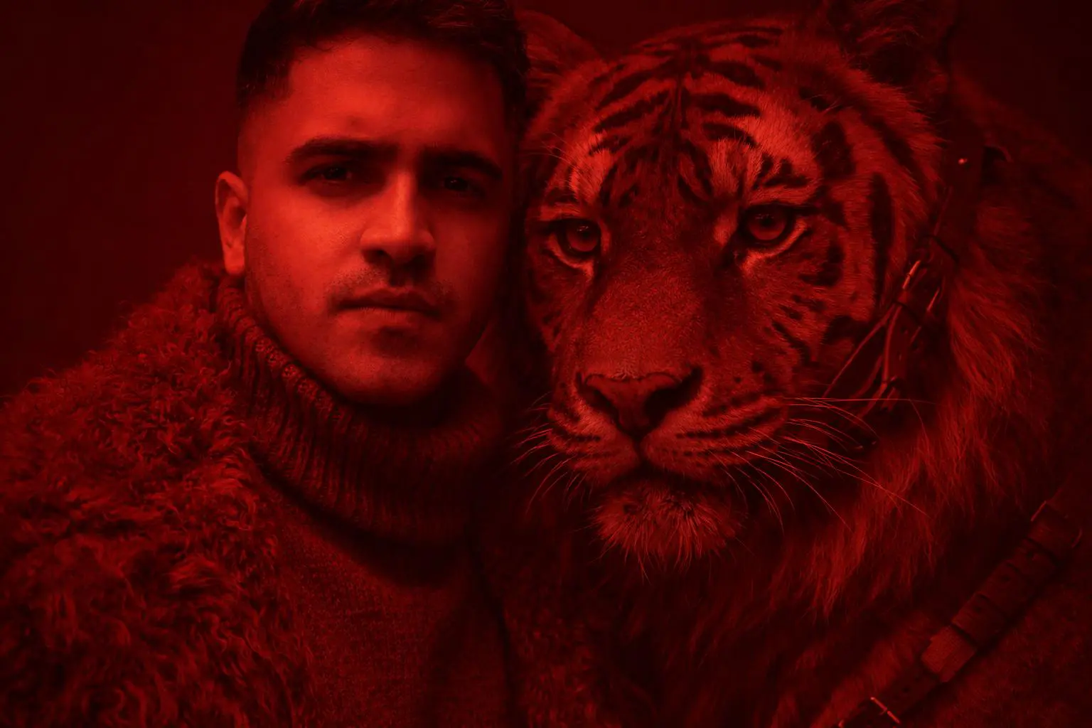 Arshaan Gandhi, wedding and celebrity photographer, photographed alongside a tiger under deep red light